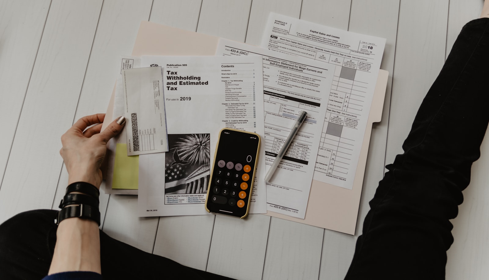 Financial paperwork and a calculator for planning how to pay for senior care